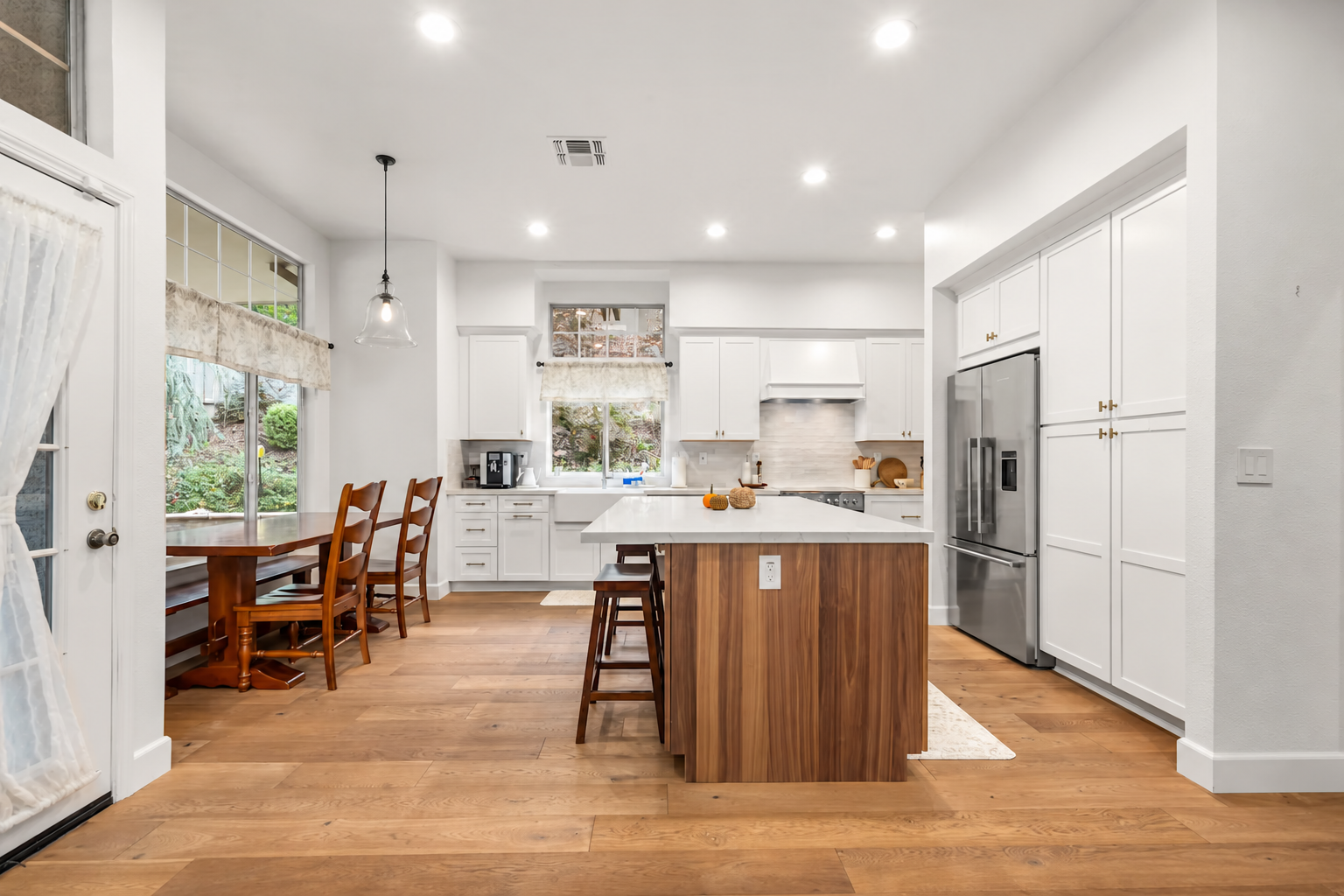 Completed Folsom kitchen with white cabinetry and a natural wood island