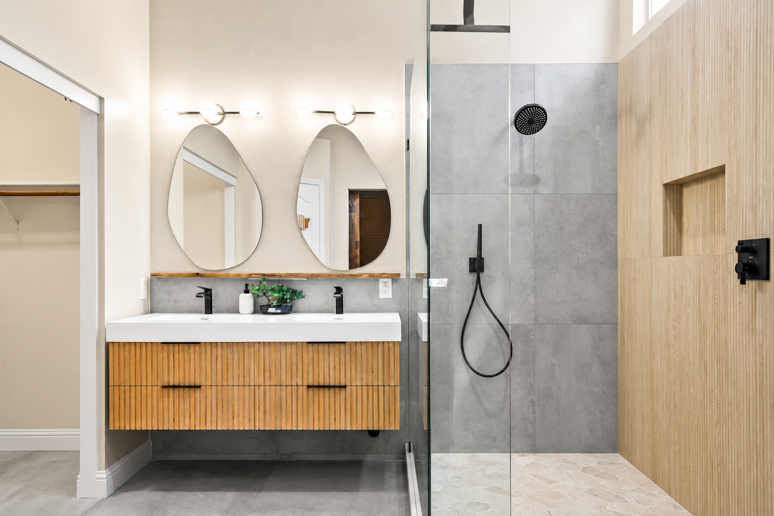 Completed Roseville bathroom with a floating wood vanity and walk-in shower